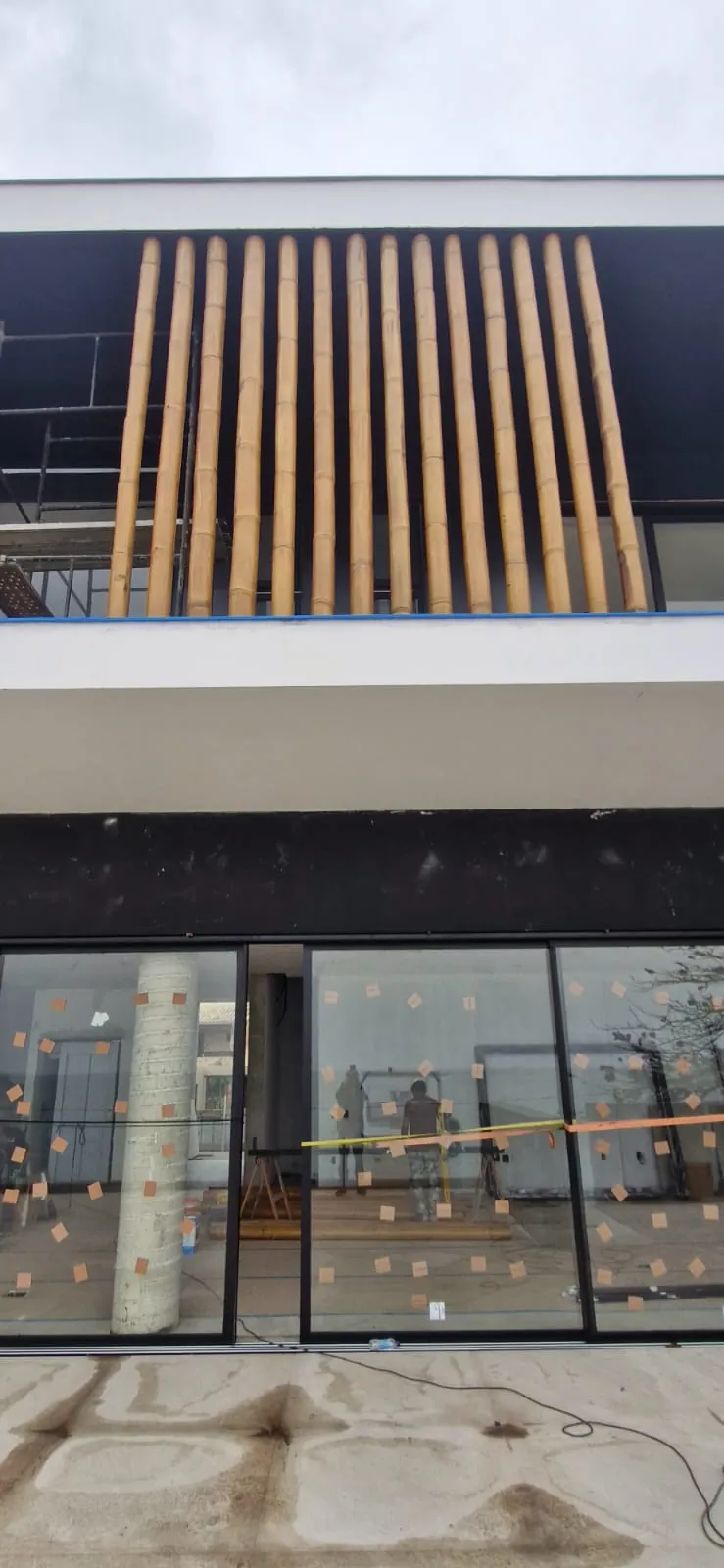 Casa Bombinhas: fachada com brise e revestimento de bambu, registro de obra.